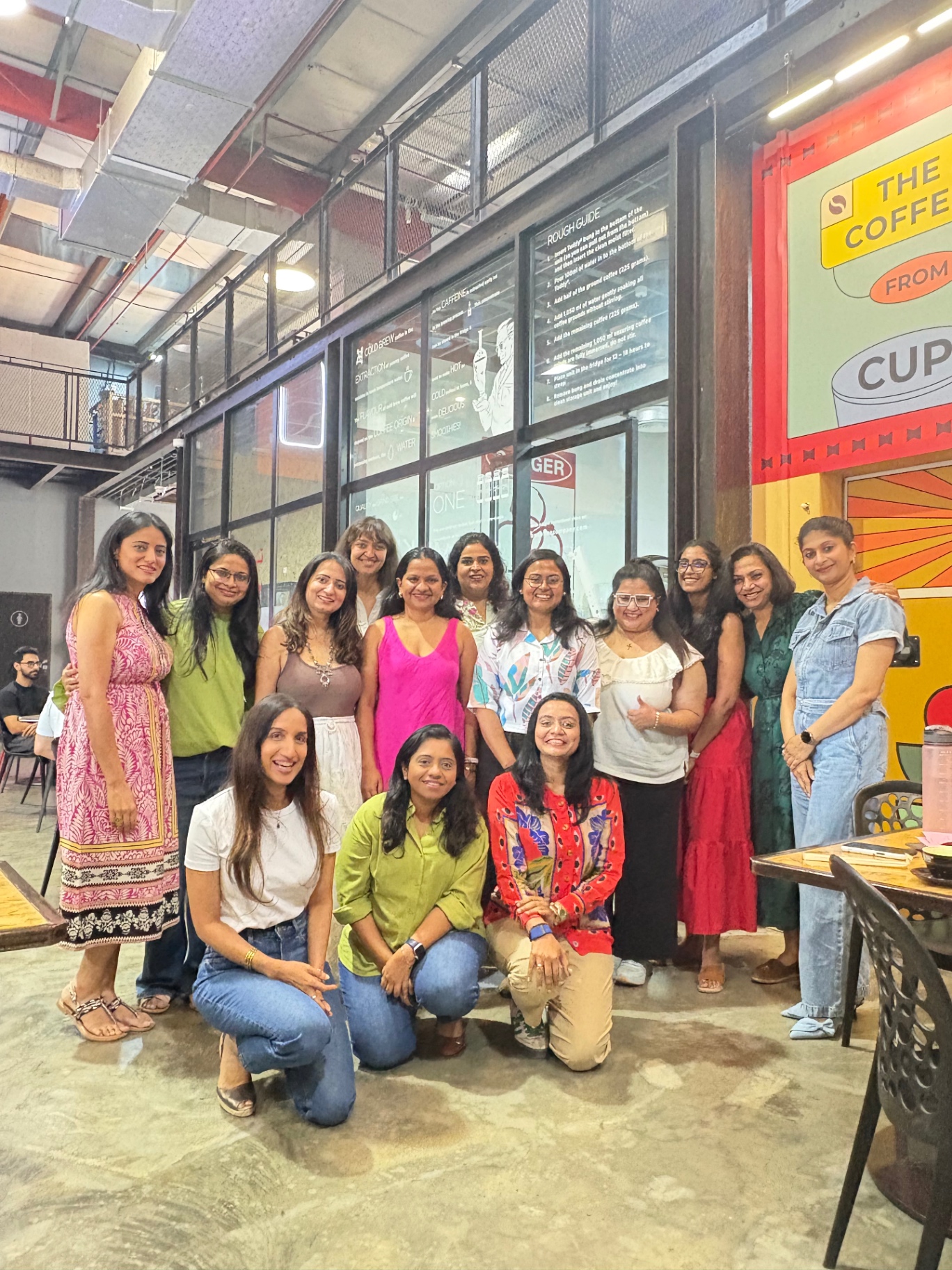 A large group of Fempower women smiling together at a community gathering